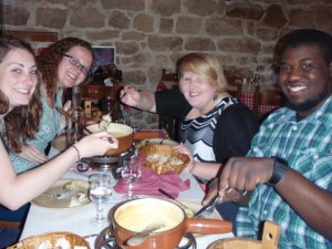 Courtney, Courtney, Claire, and Delancey sample fondue